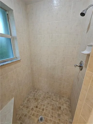 Bathroom featuring tiled shower