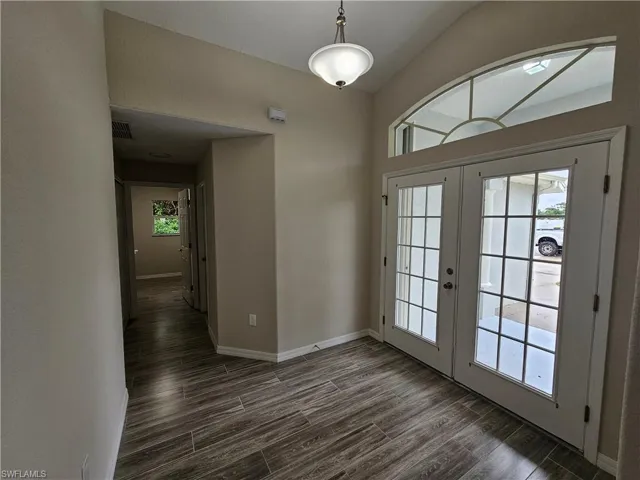 Entryway with french doors and dark hardwood / wood-style flooring