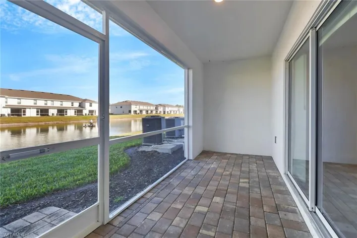 Unfurnished sunroom featuring a water view