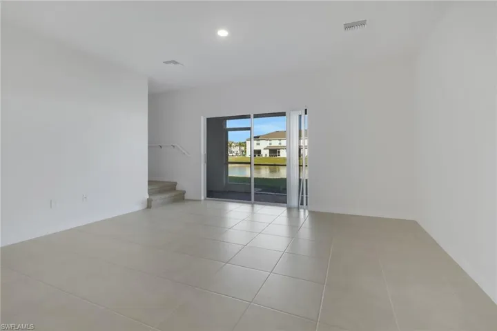 Tiled family room featuring a water view