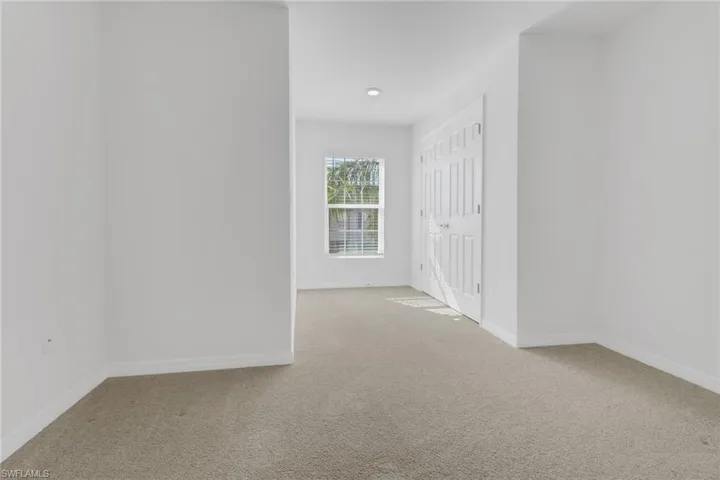 Spare room featuring carpet