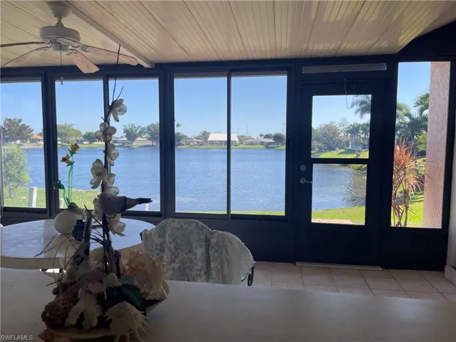 Sunroom with a water view and wood ceiling