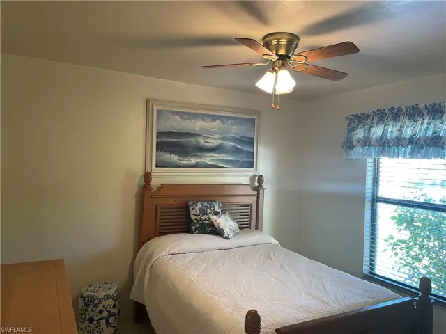 Bedroom featuring multiple windows and ceiling fan