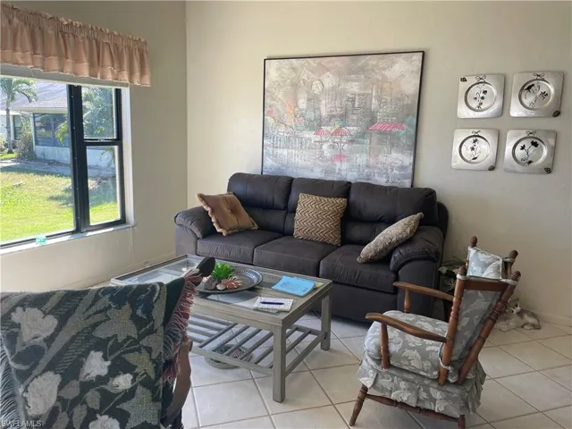 Living area featuring light tile patterned flooring