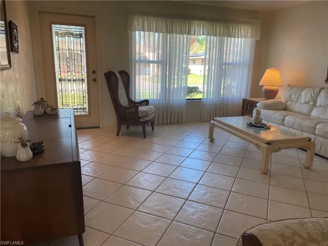 Living area with light tile patterned floors