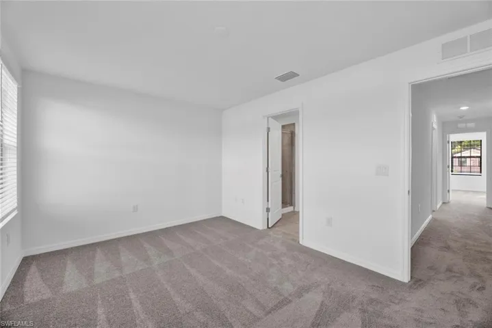 Unfurnished room featuring light carpet