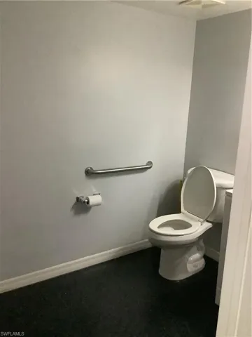 1st Bathroom with baseboards and toilet