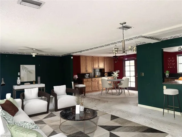 Living room featuring a textured ceiling and ceiling fan