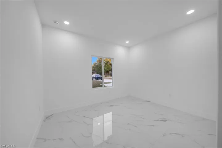 Empty room with recessed lighting and light marble finish flooring