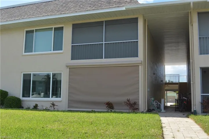 View of property exterior featuring storm shutter.