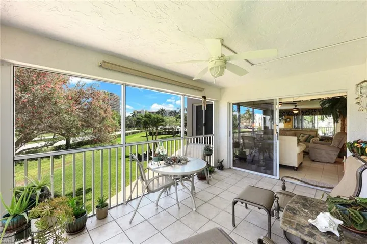 Sunroom featuring a ceiling fan