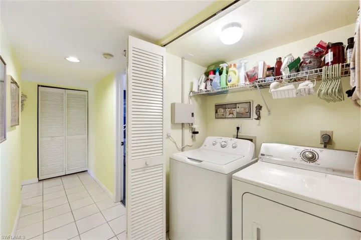 Laundry area with light tile patterned floors, baseboards, laundry area, recessed lighting, and independent washer and dryer