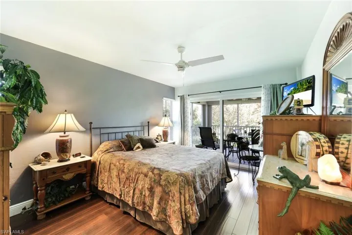 Bedroom featuring ceiling fan, wood finished floors, and access to exterior