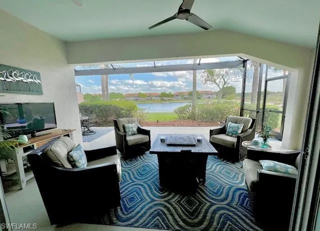 Sunroom featuring a water view, ceiling fan, and a wealth of natural light