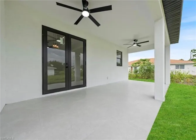 View of patio with a ceiling fan and french doors