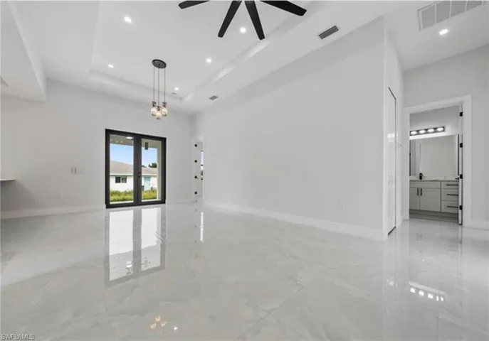 Unfurnished room featuring light marble finish floors, recessed lighting, and a ceiling fan