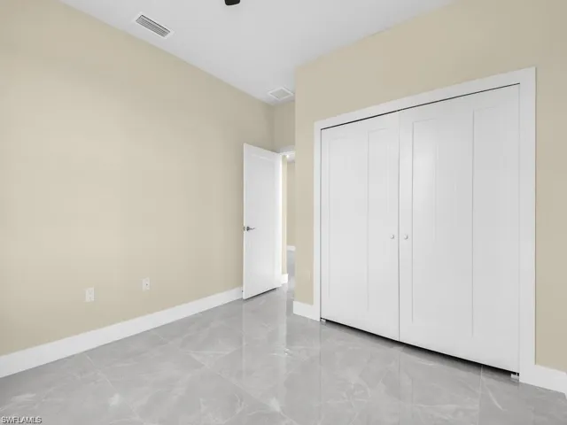 Unfurnished bedroom featuring baseboards and a closet