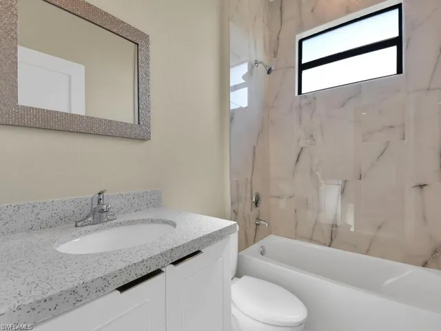 Bathroom with vanity and shower / tub combination