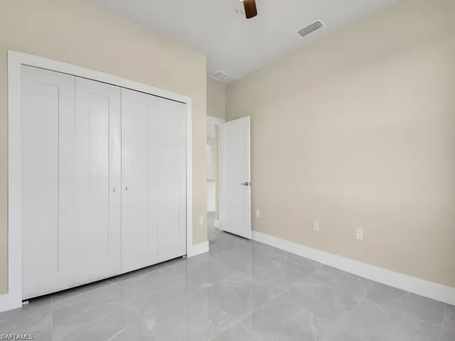 Unfurnished bedroom with a closet and a ceiling fan