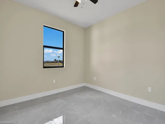 Spare room featuring baseboards and a ceiling fan