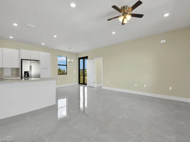 Unfurnished living room featuring ceiling fan and recessed lighting
