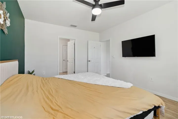 Bedroom with ceiling fan and hardwood / wood-style floors