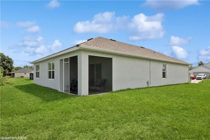 Rear view of house with a lawn