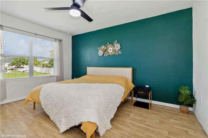 Bedroom featuring wood-type flooring and ceiling fan