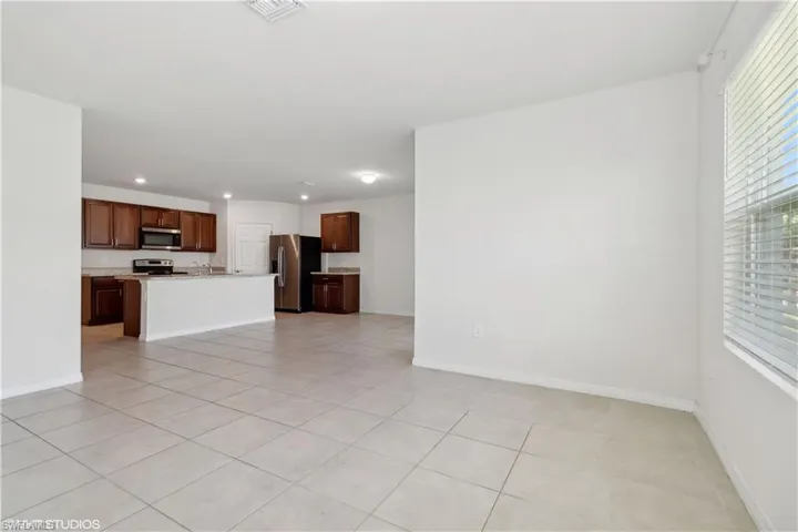 Unfurnished living room featuring light tile floors