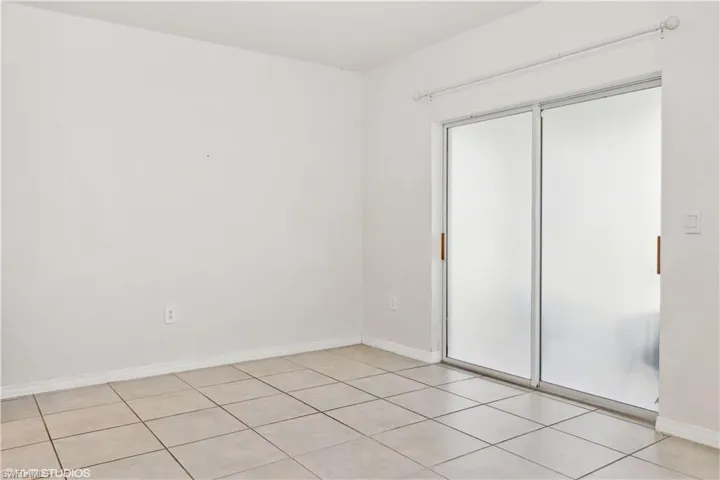 Unfurnished bedroom featuring a closet and light tile flooring