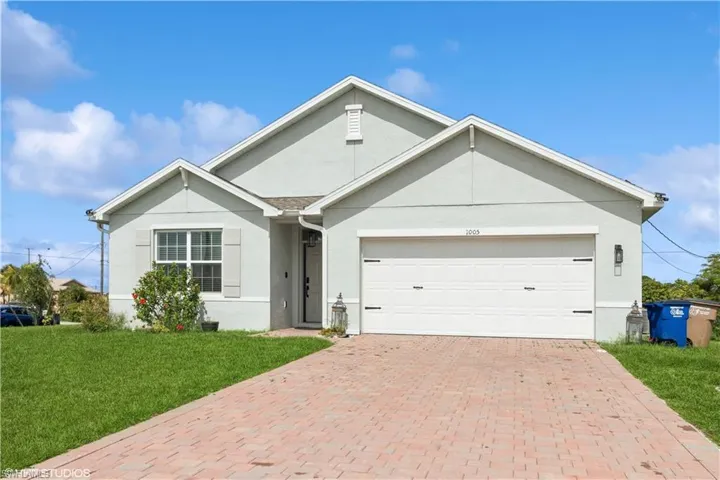 Ranch-style home with a front yard and a garage