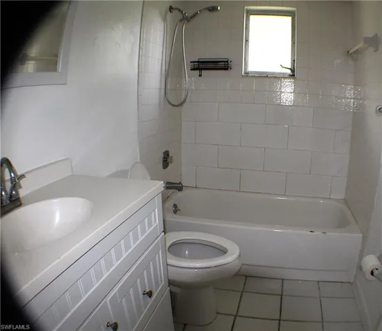 Full bathroom featuring bathtub / shower combination, tile patterned flooring, and vanity