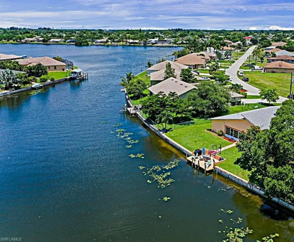 Aerial view of residential area featuring a large body of water
