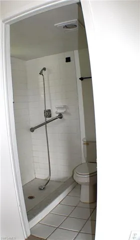 Bathroom with tile patterned flooring and a stall shower