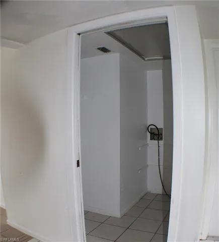 Bathroom featuring light tile patterned floors and baseboards