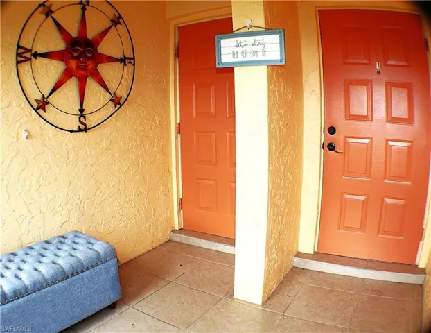 Entrance to property with stucco siding