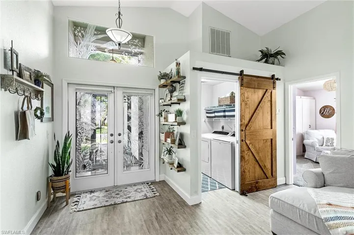 Entry Showing Barn Door to Laundry Room Open