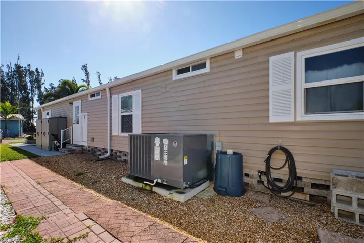 Back of property featuring central AC and entry steps