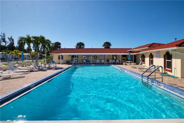 Community pool featuring fence and a patio area