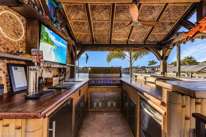 View of Amazing Tiki Bar with area for grilling and a sink