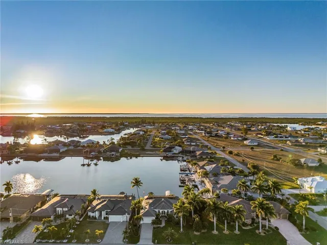 Aerial view at dusk of a water view and a residential view