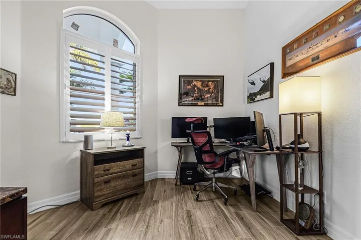 Home office featuring wood finished floors and baseboards