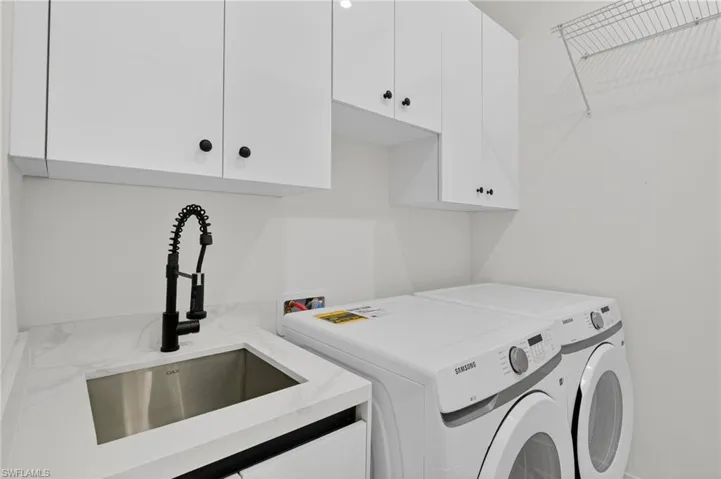 Laundry room featuring washer and clothes dryer