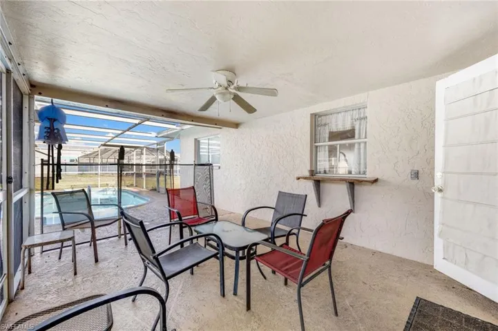 View of patio / terrace with a lanai, ceiling fan, and a fenced in pool