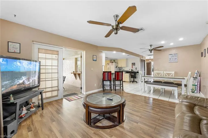 Living room with french doors, light hardwood / wood-style flooring, and ceiling fan
