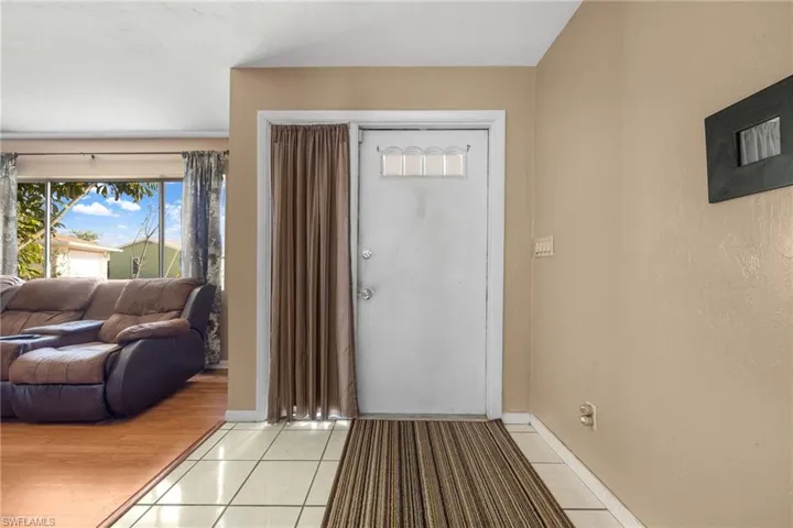 Foyer featuring light tile patterned floors