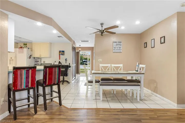 Dining area with ceiling fan and light hardwood / wood-style flooring