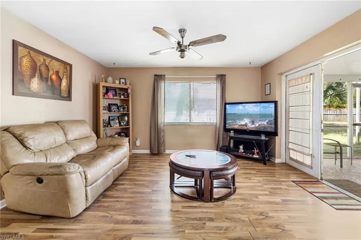 Living room featuring ceiling fan, light hardwood / wood-style flooring, and french doors