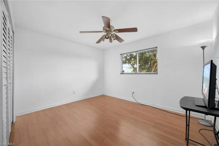 Living room with ceiling fan and light hardwood / wood-style floors