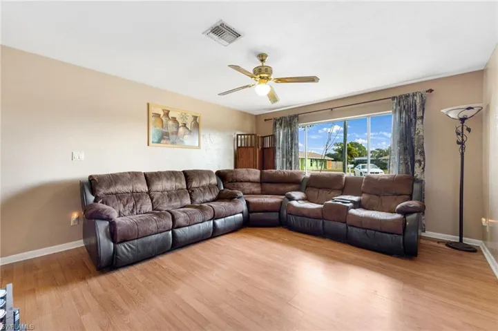 Living room featuring light hardwood / wood-style flooring and ceiling fan